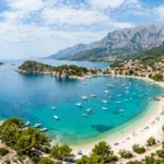 Turquoise water and a white pebble beach along the Croatian Adriatic coast, one of the best beaches in Croatia